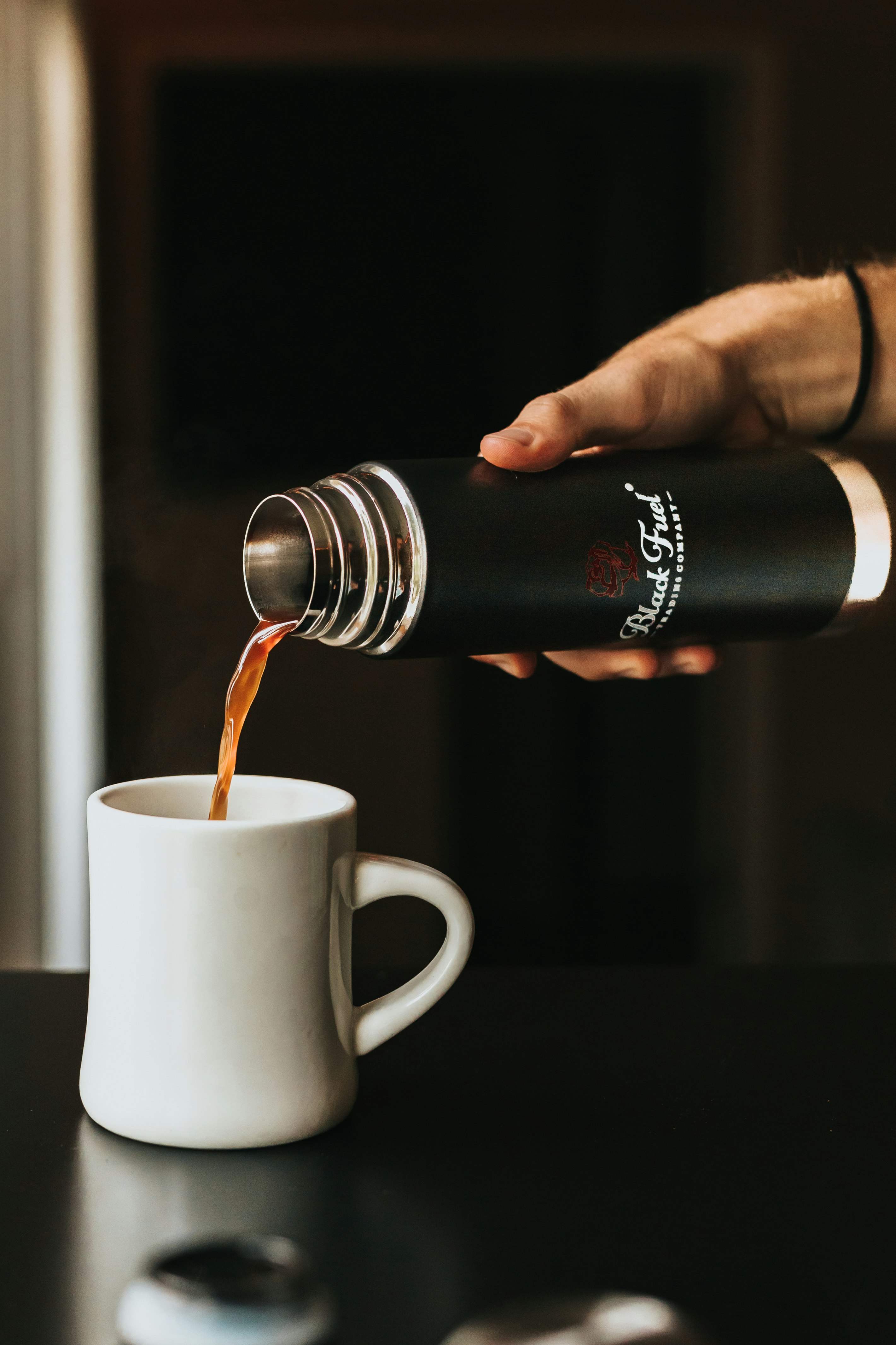 person holding thermal carafe